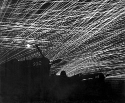 Ryukyu Islands Okinawa, Japan Yontan airfield AA against Japanese night raiders during WWII; F4Us Hell&rsquo;s Belles squadron in fore.photo by T. Chorlest, 1945