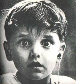 Shot by photographer Jack Bradley: the exact moment this boy, Harold Whittles, hears for the very first time. The doctor treating him has just placed an earpiece in his left ear. Date unknown.