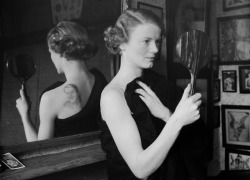 fawnvelveteen:A film fan uses a mirror to admire the image of film star Gary Gooper she has had tattooed on her back by George Burchett a London tattooist, 1936.