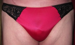 Black laced sides on this red satin thong.
