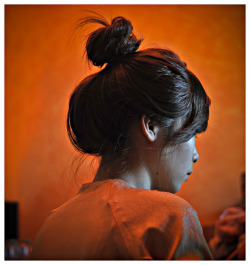 noipictures:   				A Vietnamese girl sitting in an orange room wears her hair in a high bun, Nha Trang, Vietnam, Southeast  Asia  © Thiery Beyne / NOI Pictures  Vietnam &amp; Southeast Asia Stock Photography 