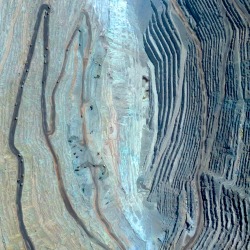 dailyoverview:Massive haul trucks remove copper from Chuquicamata, the largest open-pit copper mine in the world. Located in the Antofagasta Region of Chile, the 850 meter (2,790 ft) deep site has enabled the extraction of more than 29 million tonnes
