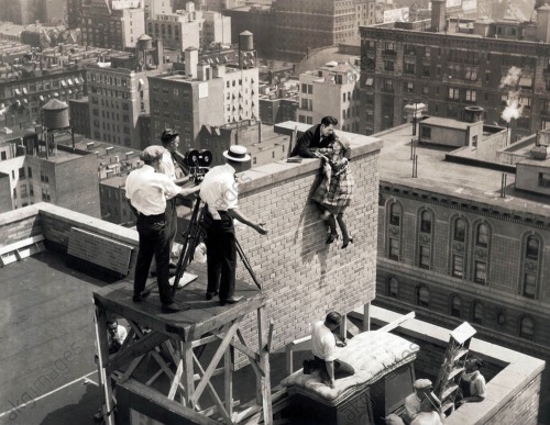 A stunt scene atop the Algonquin Hotel with star Allene Ray hanging on and Walter Miller doing the life saving…. for the Pathé Exchange film &lsquo;Play Ball&rsquo;, 1925 Nudes &amp; Noises  