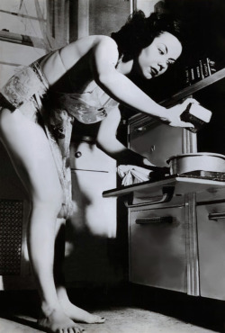 Vintage press photo from June of ‘53 features Burlesque dancer Kalantan posing in her kitchen.. In accompanying newspaper articles, Kalantan proclaimed her unease with working as a stripteaser: “I hate to strip. I’ve never gotten over being embarrassed