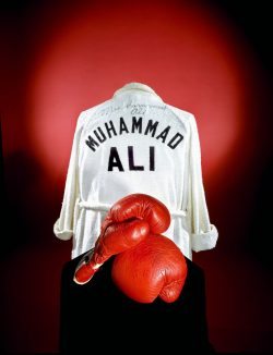 smithsonian:  Today we reflect on the legacy of Muhammad Ali. Known as “The Greatest,” he gained fame for his boxing skills, charisma, and the controversy he generated outside the ring.In 1976 the Smithsonian acquired Ali’s boxing gloves and robe,