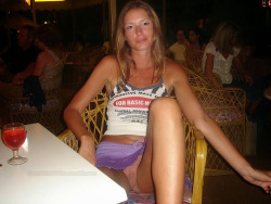 bestofexhibition:  Very daring to expose her pantyless pussy in the restaurant full of people in shuch a micro skirt!
