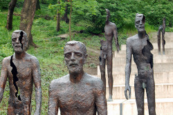 sixpenceee:  Memorial to the Victims of Communism, This is located in Prague, Czech Republic. It shows seven bronze figures descending a flight of stairs. The statues appear more “decayed” the further away they are from you, losing limbs and their