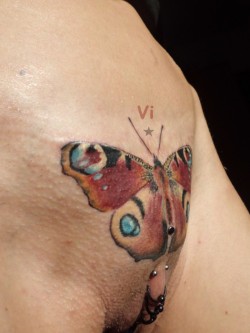 Pierced pussy with a butterfly tattoo.