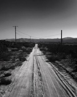 ryanallanphoto:  Forced perspective, dirt road, black and white, telephone poles… I frolic in cliche. #busylivin