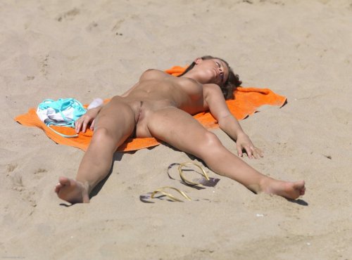 Naked women sunbathing on beach