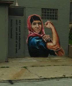 shepherdsongs:  I was driving past a business here in the Houston Heights, when I glimpsed this painted on the side of the building. I recognized that iconic WWII poster before I realized it was not just any woman, but 14 year old Malala Yousafzai, the