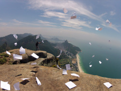  tha guy on the cliff he just finished highschool and what he did was he threw all his school papers and books over the cliff screaming “take that” personally i think that its really cool because in a way its like hes free. He went through four years