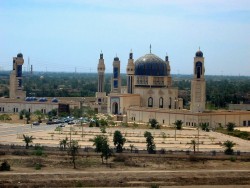 Umm al-Qura mosque in April 2004, showing three of the four perimeter minarets, each resembling a Kalashnikov rifle, and three of the four minarets around the dome each in the shape of a Scud missile on its Launchpad.Photo by me :-) I think it’s the