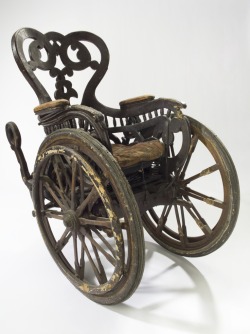 Invalid chair, Europe, 1850-1890: Unlike modern wheelchairs that have four wheels, this chair has three: two large front wheels and one small rear wheel. This means the patient was unable to wheel the chair themselves. They would have had an assistant.