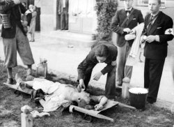 bag-of-dirt:  Polish medics attend to a civilian who was severely injured during the German Luftwaffe&rsquo;s aerial assault on Warsaw following German invasion of Poland. Warsaw, Masovian Voivodeship, Poland. 1 September 1939.