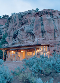 sleepingonparktables:One of several places I stayed in Colorado. Built into the canyon cliff, one entire side of the house is rock; the shower and reading corner are natural recesses. Wood-burning stove, heated tile floors, and 2nd story loft for guest