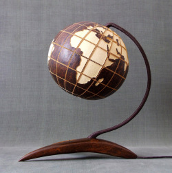 psychoactivelectricity:  This lamp is made of Senegalese gourd.   Meridians and circles of latitude are marked every 20 degrees; the contours of the continents are reconstructed accordingly. The land is marked by a deeper layer of white wood which allows