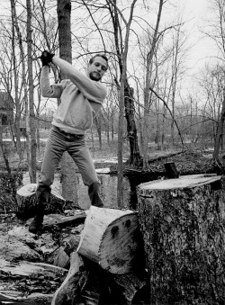  Paul Newman photographed by Philippe Halsman chopping wood, 1963.   