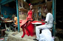 naked-african-girl:  A model poses in front of tailor stalls in the center of Dakar, Senegal http://bit.ly/1JybAWv