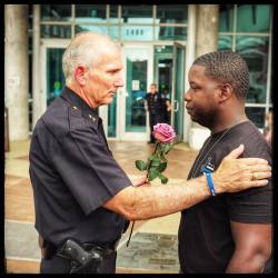 lensblr-network:  June 10, 2016“Crossing that Bridge”Yesterday Assistant Chief of Police Gary Tittle tried to comfort this young man in front of the police station where a memorial was erected for people to come and grieve.Originally I had walked
