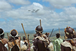    Dec. 15, 2013. A group of Zulu warriors, from KwaZulu Natal watch a flypast from near a public viewing tent during the burial of former South African president Nelson Mandela in Qunu, South Africa. 
