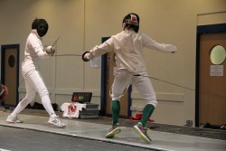 modernfencing:  [ID: several photos of an epee bout.]leftyguitarist:  This is me fencing at Roses- I’m the one with green socks. I know my posture looks weird but I spent a lot of time jumping backwards. Also check out that quality wrist hit.