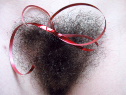 baretobush:Day 100. I’m not much of a holiday person, but I couldn’t resist the opportunity to tie a piece of red ribbon to my pubic hair.