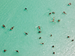 sunfornia:  fairhy:   Dead Sea, Israel Photograph by George Steinmetz, National GeographicSwimmers float effortlessly in the salt-laden waters of the Dead Sea near Ein Bokek, Israel. Ten times saltier than seawater, the lake is extremely buoyant and a
