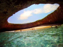 atlasobscura:  Hidden Beach - Mexico A gaping hole in the surface of the lush green island exposes a secret beach, with ample shade, sun and crystal-clear water. The Marieta Islands are an archipelago, a chain of islands that exist as a result of volcanic