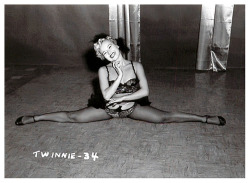  Twinnie Wallen displays her flexibility! From a photo series shot by Irving Klaw, during the production of his films: ‘VARIETEASE’ and ‘TEASERAMA’.. 