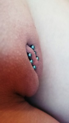 pussymodsgaloreShe has pierced inner labia with three barbells through them. Chastity piercing.