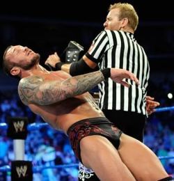 Orton bulging, after getting hit with the world title! Must like it rough! &gt;:)