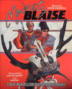 Modesty Blaise: The Warlords of Phoenix, written by Peter O’Donnell, illustrated by Jim Holdaway and Romero (Titan Books, 1986). Cover art by John M. Burns.From Oxfam in Nottingham.