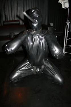 strappedown:  Unfortunately for Zach, the rigid rubber gag in the gimp suit made his pleas unintelligible. From the outside his repeated cries of “Please, Sir, Let me out soon!” sounded more like “This suit is awesome!” and his non-stop struggling