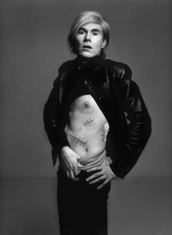 Andy Warhol in 1969, showcasing the scars left on his body after surviving a shooting by Valerie Solanas the year before. Photo by Richard Avedon.