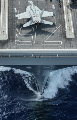 militaryarmament:  A Boeing EA-18G Growler assigned to the “Gauntlets” of Electronic Attack Squadron 136, taxies the flight deck of the aircraft carrier USS Ronald Reagan.