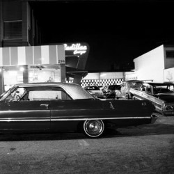 adalbertorossette:  Impala estacionado na frente do Cadillac Burger na Mooca. Fotografia que integra o documentário South American Cholo. #southamericancholo #cars #lowrider #tattoo #bike #cholo #culture #documentary #impala