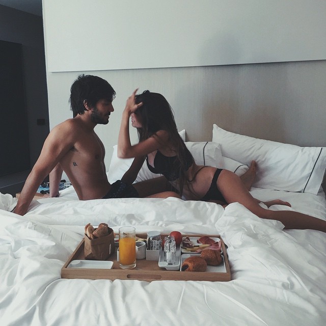 Romantic couple in bed morning coffee