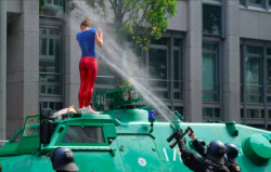 German fashism is alive and kicking in 2017. OR: Stupid leftist cunt with red shiny leggings has climbed onto a police vehicle and is sprayed with water pistols in order to expose and shame her with a wet T-Shirt. [”However, the opposite is also true.”]