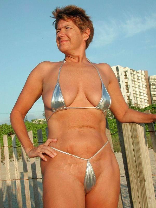 Mature milf in a thong on the beach