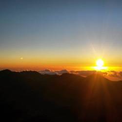 Sunrise breaking through the cloud cover over the ocean at Haleakala summit in Hawaii. #femdom #mistress #vacation #sunrise #hawaii #volcano #haleakala #horizon #daybreak #ocean #nationalpark #dawn #aurora #clouds #mountains #magical #pacificocean #island