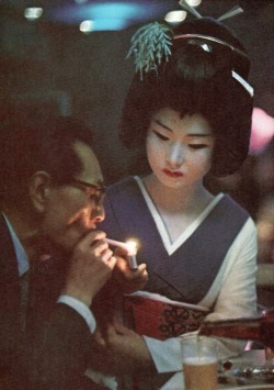 richmondcee:  Patron of Nightclub Uruwashi Having His Cigarette Lit by Geisha 