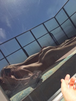 Sun tanning and appreciating the balcony window&rsquo;s reflection 