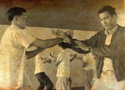 gutsanduppercuts:  A rare early photograph of Bruce Lee practicing Wing Chun (with his eyes closed!?).