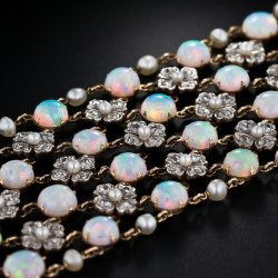 diamondsinthelibrary:  Belle Epoque opal and diamond choker necklace, circa 1900. With four rows of opals and three rows of pearl and diamond flowers, this antique choker has 80 carats of opals (78 stones), 232 rose cut diamonds (7 carats), and 96 pearls.