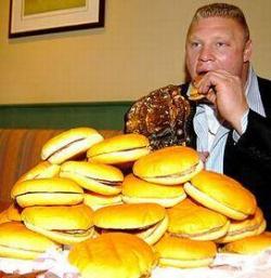 perversionsofjustice:bryansbeard:  please stop what you’re doing and enjoy this photo of brock lesnar eating a mountain of hamburgers   Yeah well I bet he couldn’t beat Seth Rollins in a hot dog eating contest