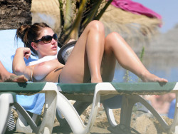 toplessbeachcelebs:  Lucy Pinder (British Model) sunbathing topless on the beach (December 2010)