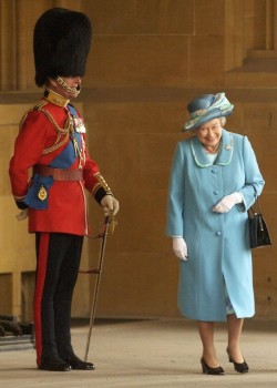 Jocularity (Queen Elizabeth laughs as she walks by her husband Prince Philip, the Duke of Edinburgh, in his full dress uniform)
