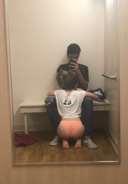 nordicgirlslust:This photo is really good at showing interracial dynamics. They were in the changing room, trying on clothes, and he decided that right now she was going to go down on him. She obediently complies, and he snaps this shot to brag that