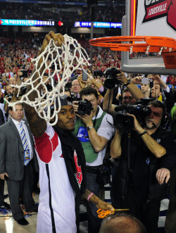 sportainment:  Louisville Cardinals injured guard Kevin Ware cuts down the net after Louisville won the championship game in the 2013 NCAA mens Final Four against the Michigan Wolverines at the Georgia Dome. 